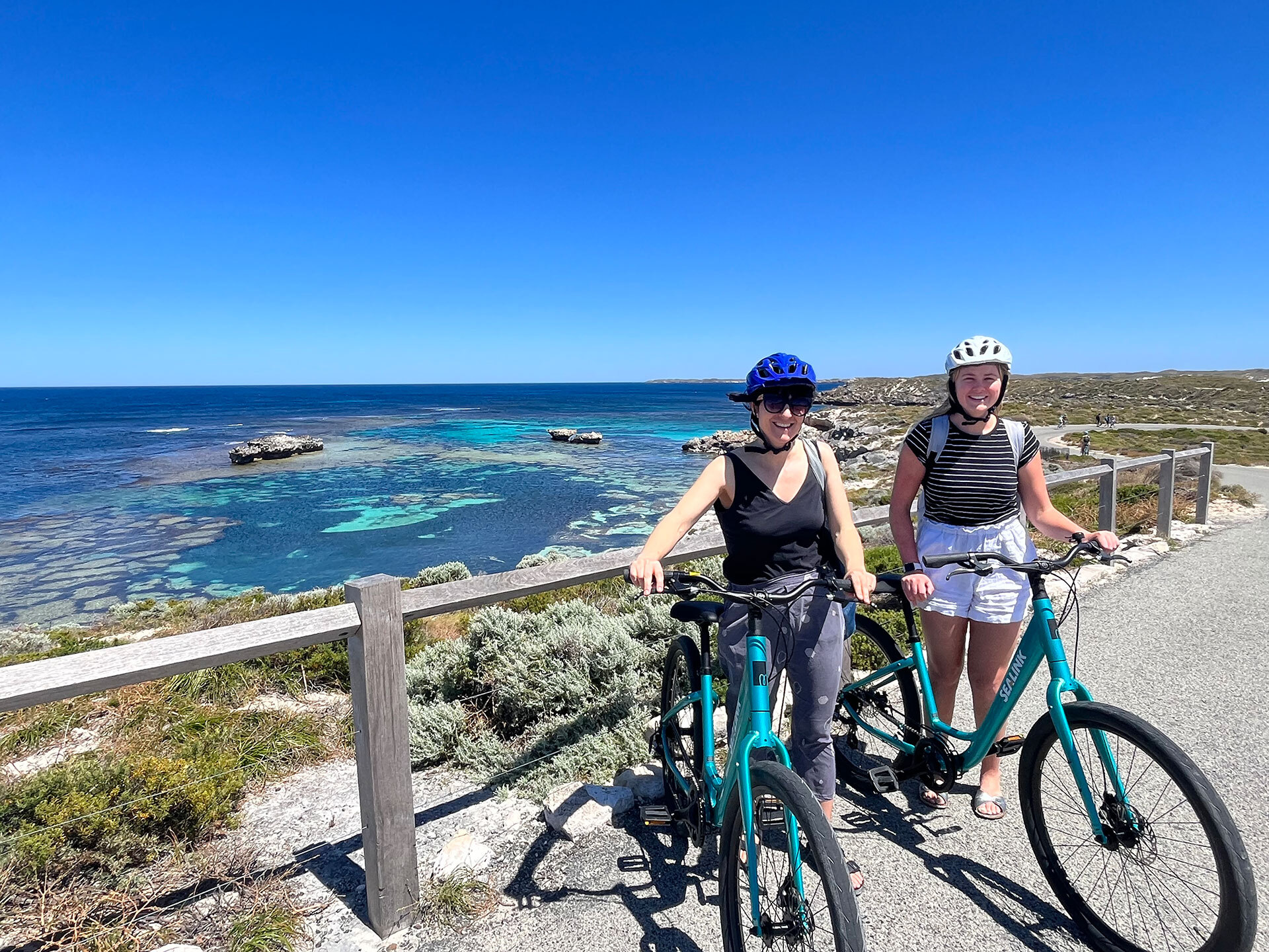 Two young ladies with bikes on the coast at Rottnest Island