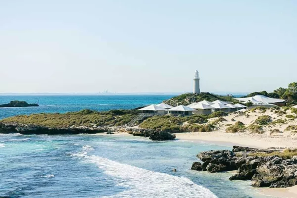 View of over Pinky Beach to the Rottnest Island glamping accommodation with Bathurst Lighthouse in the background