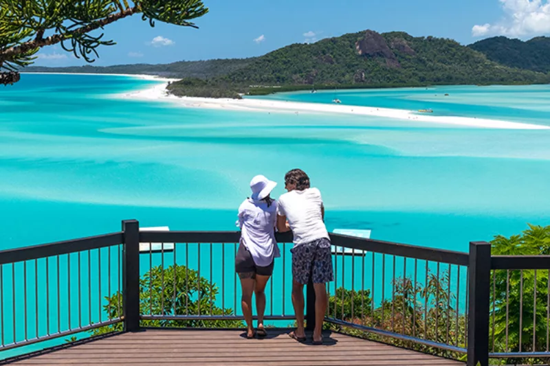 A couple at Hill Inlet look out at the view of the Whitsundays Island