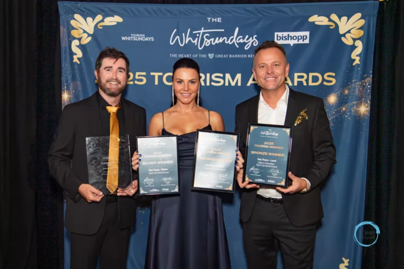 Nathan Linnell, Julie Telford and Asher Telford pose with their four award wins for Whitsunday Jetski Tours, Red Cat Adventures and SeaLink Whitsundays