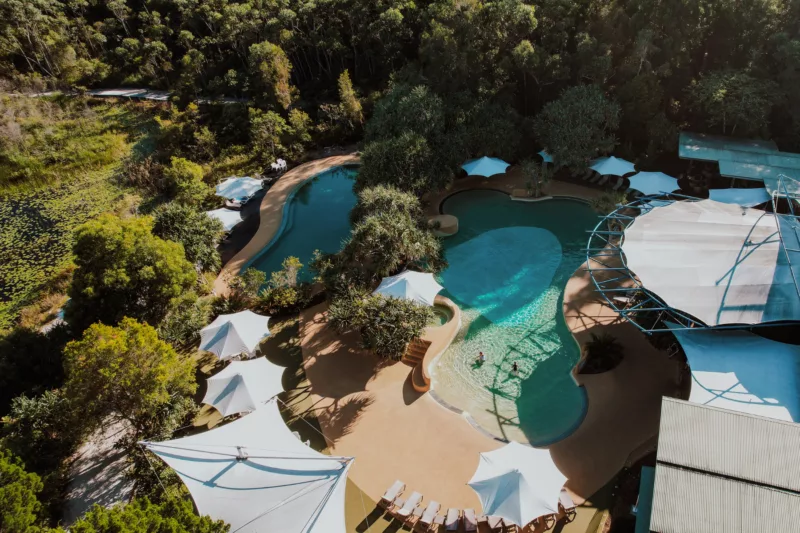 Aerial view of two lagoon-style swimming pools at Kingfisher Bay Resort.