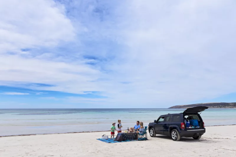 A family of four picnicking at Emu Bay beach