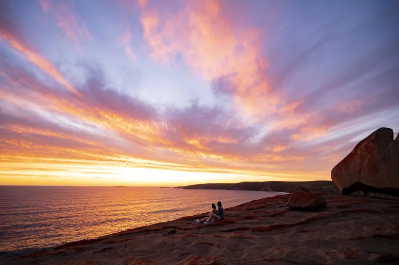 Couple sitting at Remarkable Rocks at sunset