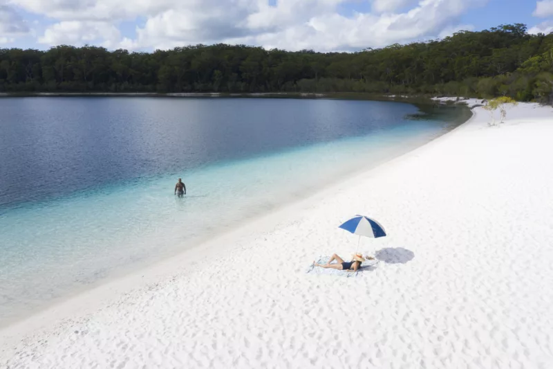 A couple enjoying the crystal-clear water at Lake McKenzie.