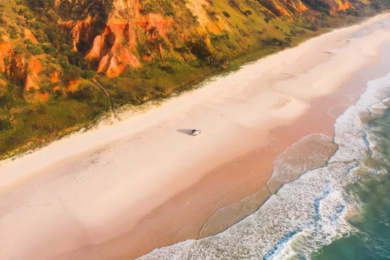A 4WD explores the shores of 75 Mile Beach
