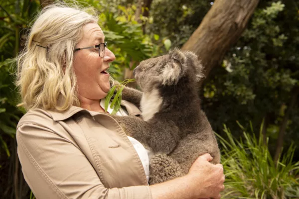 A woman holds a Koala