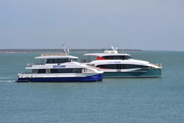Two white and blue ferries in the sea