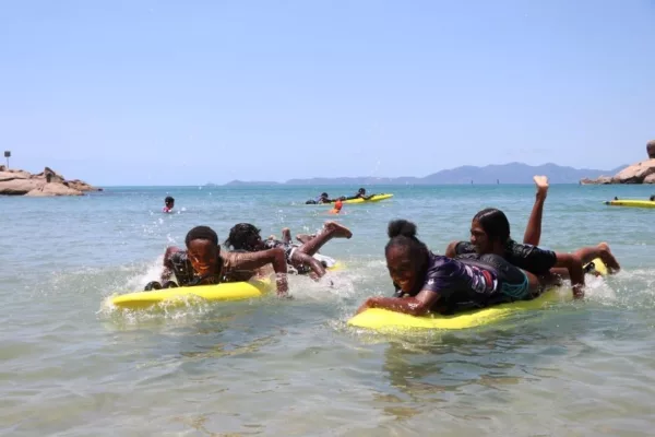 NRL Cowboys House Students on boards in water at Alma Bay