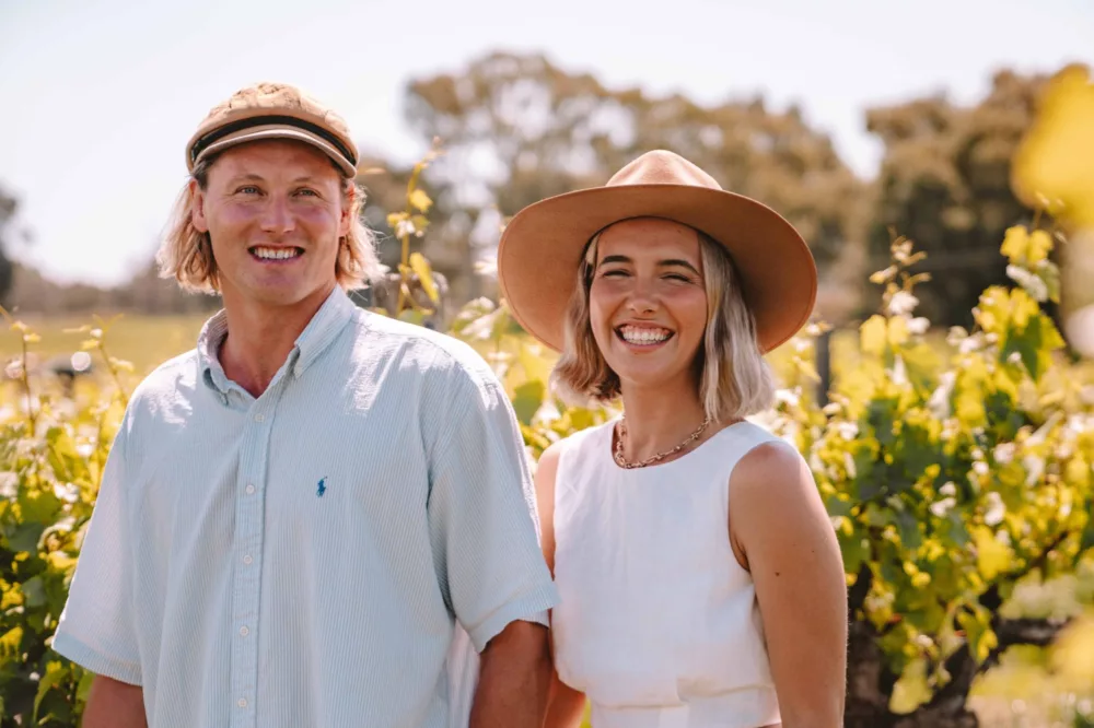 Couple walking through Swan Valley vineyards