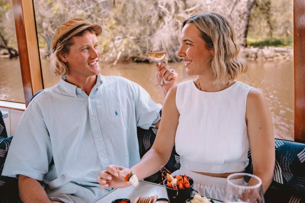 Couple enjoying lunch on board vessel to the Swan Valley
