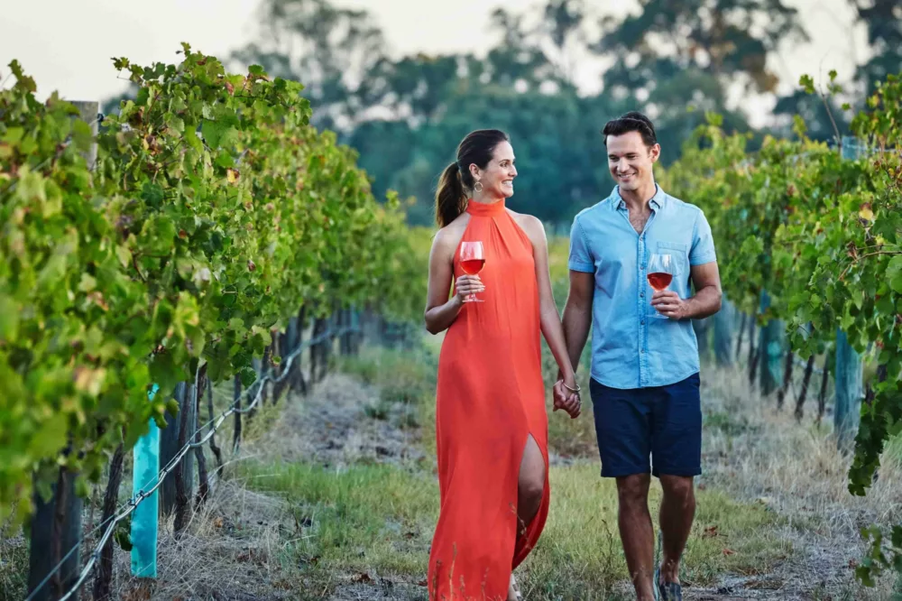 Couple walking through Swan Valley vineyards